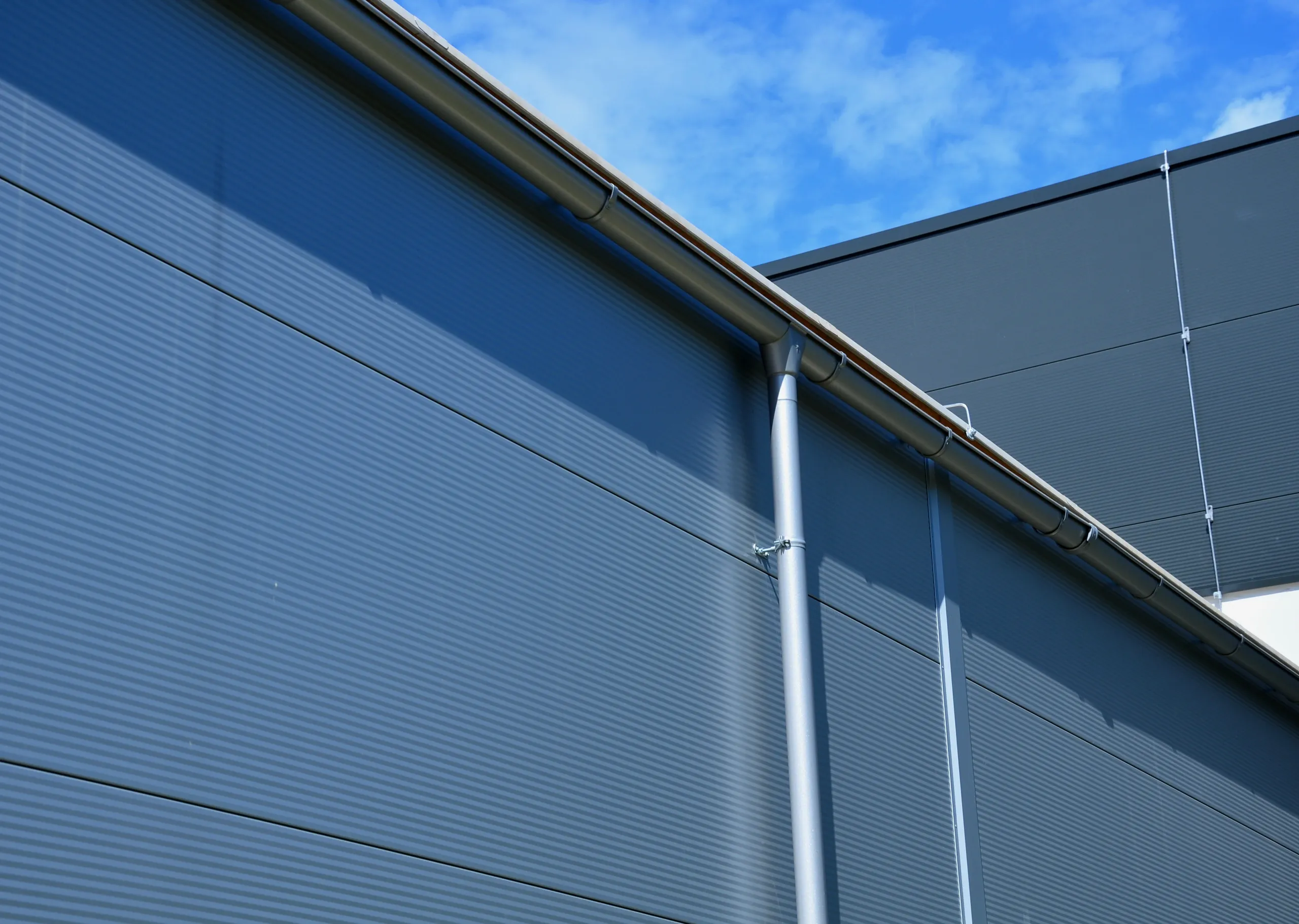 Close-up of standing seam metal roofing and guttering on a commercial building