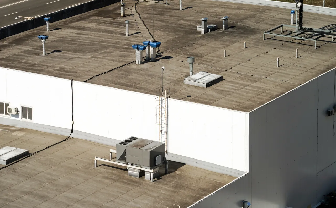 Flat roof commercial building with rooftop plant and ventilation units