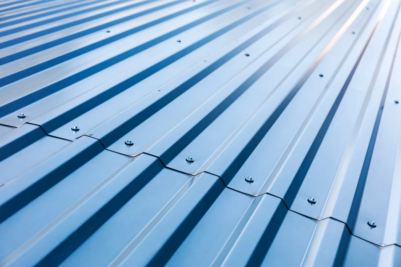 Close-up of blue standing seam metal roofing panels and fixings
